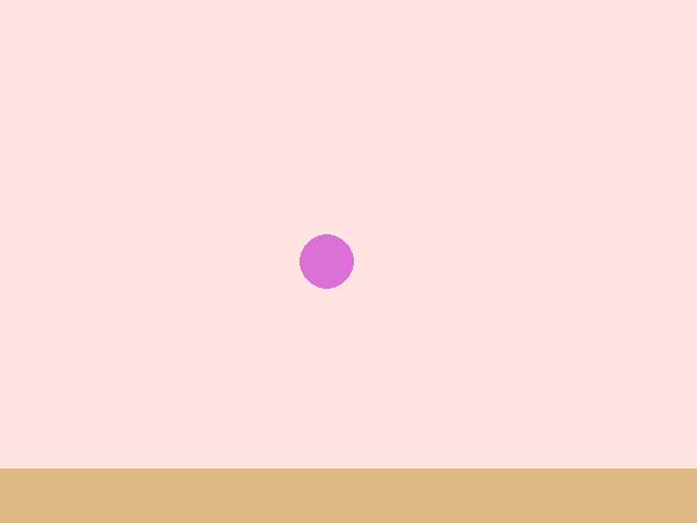 A pink bakery scene with a wooden counter along the bottom and a purple round cupcake that has slid partway across the screen.